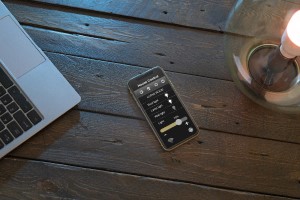 man controlling smart lamp with his phone